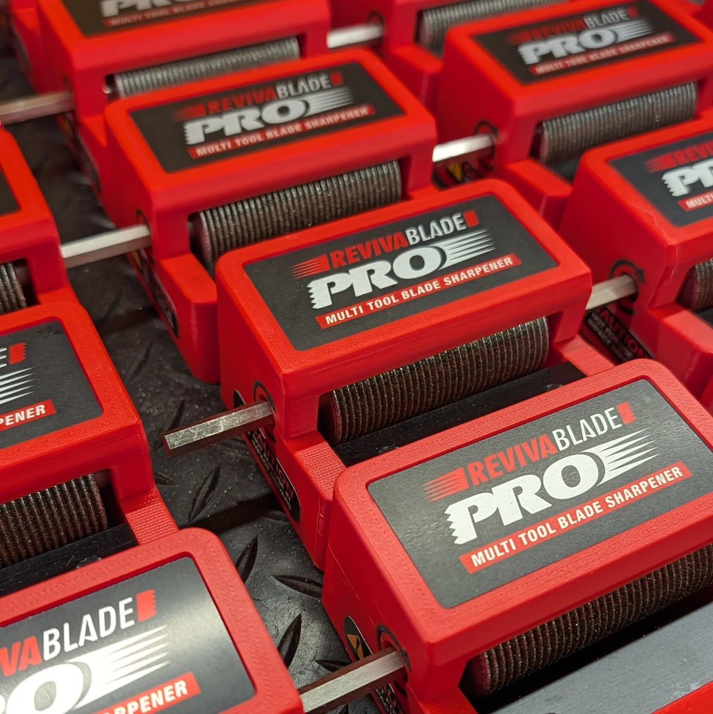 Multiple Revivablade Pro multi-tool blade sharpeners arranged in a row.